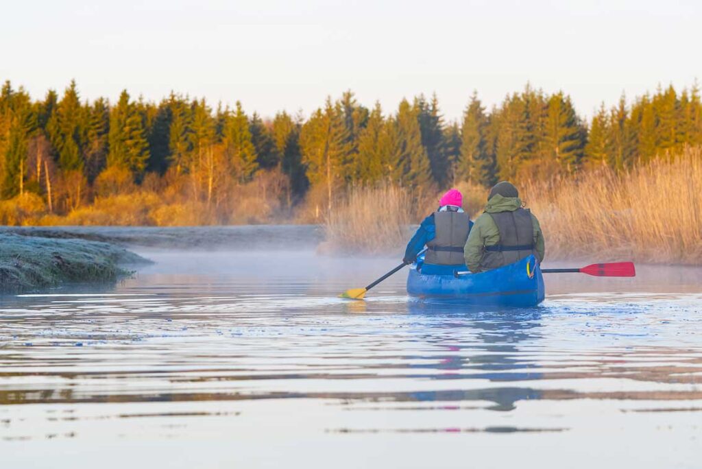 seniors rowing canoe in early spring