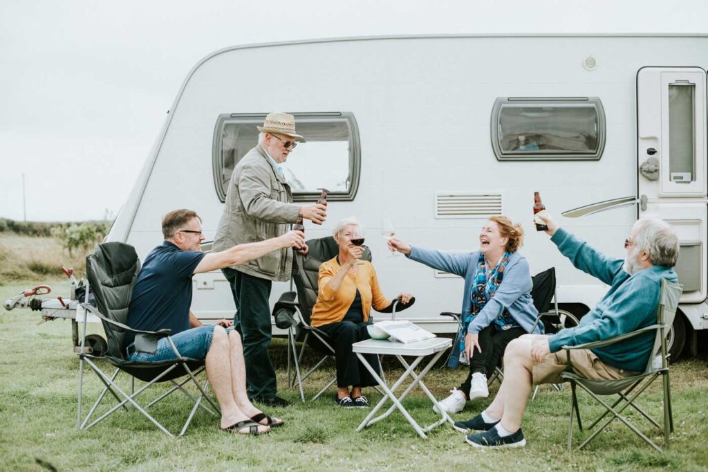 Group of seniors having fun together after taking a ride on recreational vehicle after taking an A.S.A.G. Reverse Mortgage